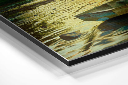 Angled close-up view of layered brushed aluminum and black-edged Dibond panel displaying weathered wooden boat detail with blue and golden tones.