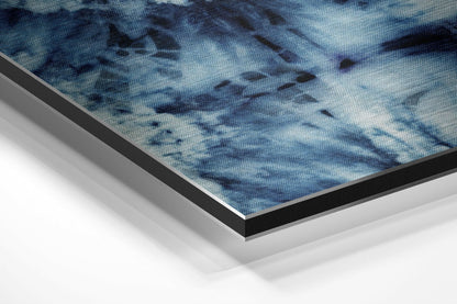 Close-up angled view of layered framing edges showing blue textured artwork with black and silver aluminum borders.