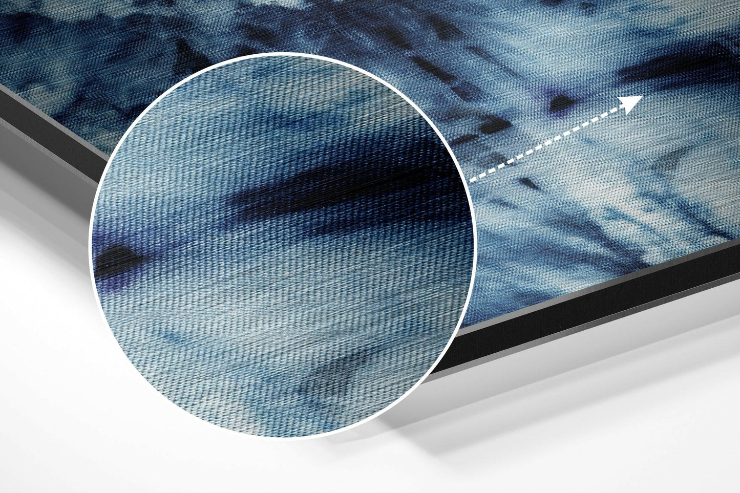 Close-up magnified circular view of brushed aluminum surface with blue and black diagonal pattern and white directional arrow detail.