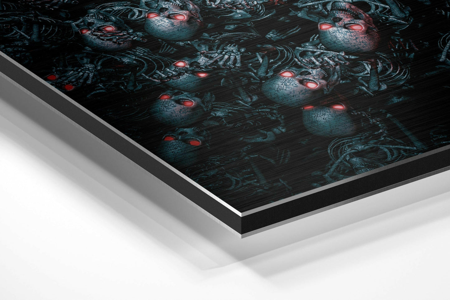 Angled perspective view of brushed aluminium Dibond wall art displaying dark teal androids with glowing red eyes on black background.