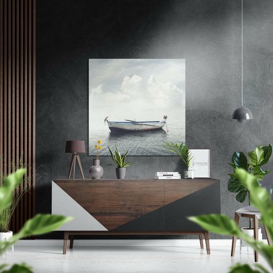 Serene seascape with blue fishing boat on calm water and white clouds, displayed on gray textured wall above wooden dresser.