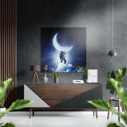 Modern living room interior with "Holding the Moon" artwork displayed above wooden console table with potted plants and pendant lamp.