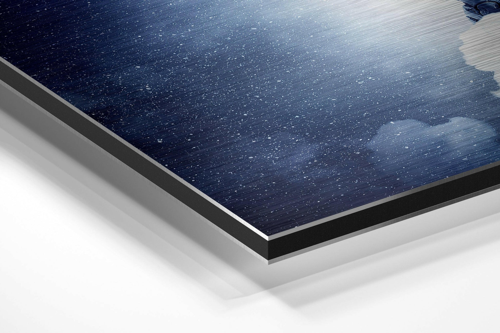 Close-up angled view of layered Dibond wall art showing dark blue starry night sky surface with silver aluminum edge and white backing layers.