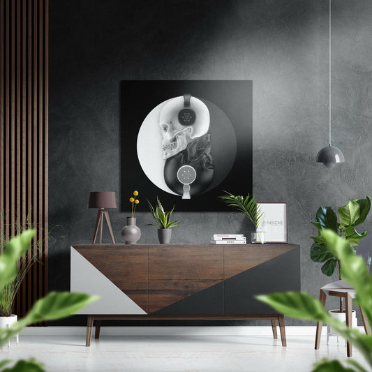 Ying Yang Skulls wall art displayed above wooden dresser in modern gray interior with plants and pendant lamp.