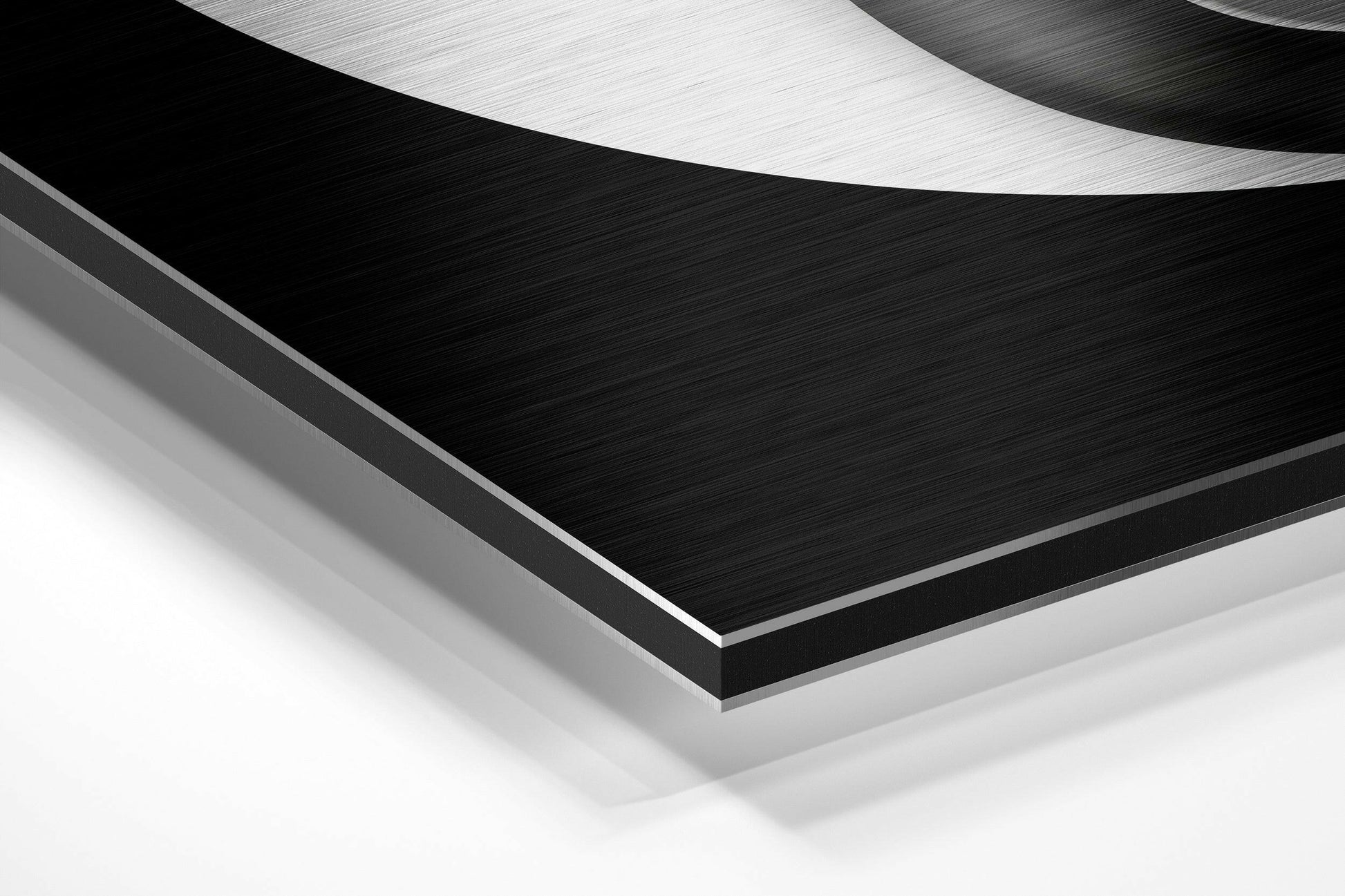 Close-up angled view of layered brushed aluminum and white composite materials showing edge detail and surface texture.
