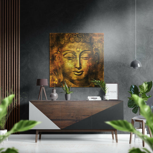Golden Buddha face portrait hanging on grey wall above wooden dresser in modern zen interior setting.
