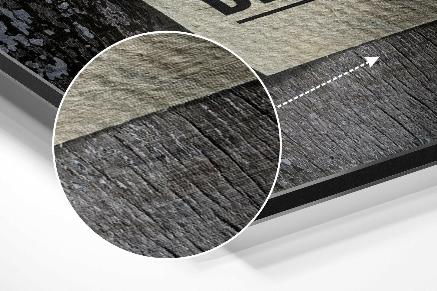 Close-up detail shot showing wood grain texture transition between light and dark brushed aluminum panels with white edge trim.