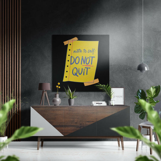 Modern interior styled with yellow motivational wall art reading "note to self: DO NOT QUIT" displayed above wooden dresser with plants.