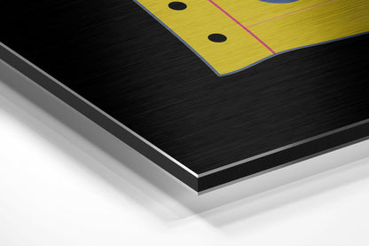 Close-up angled view of layered brushed aluminum and white material edges showing black textured surface with yellow printed section above.