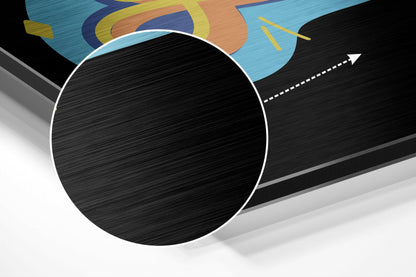 3D perspective view of brushed black aluminium circle with white border against geometric blue, orange, and yellow abstract background design.