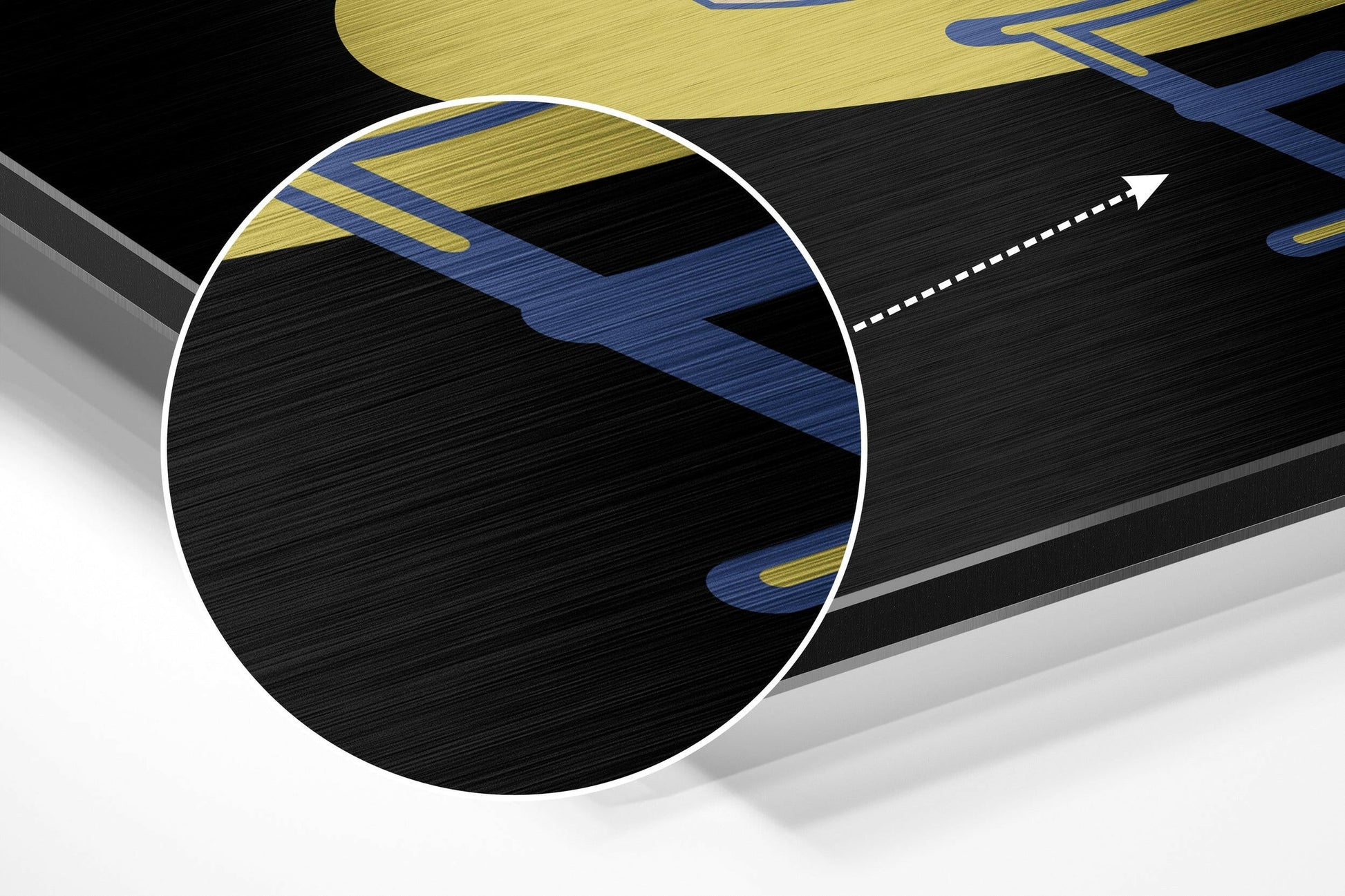 Close-up cross-section view of brushed aluminium composite material showing black core with blue and gold striped layers and white edge banding.