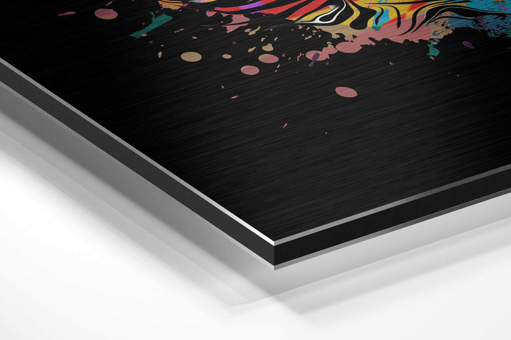Angled perspective view of brushed aluminum Dibond wall art with colorful abstract swirls and geometric patterns on black surface.