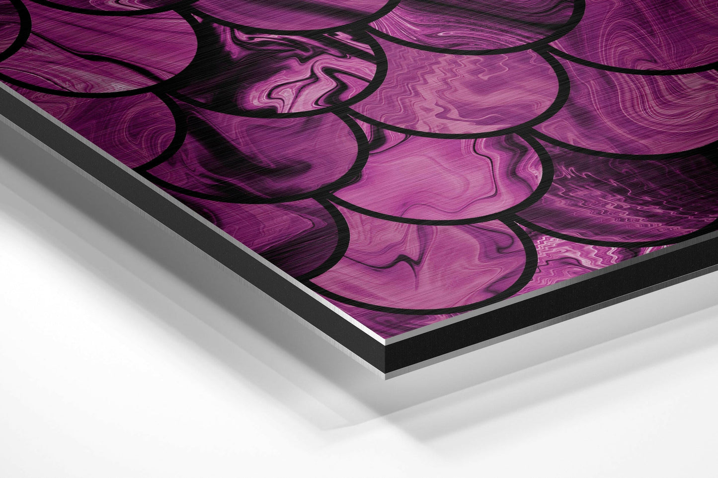 Angled perspective view of pink and black abstract brushed aluminium wall art panel with layered edge detail.