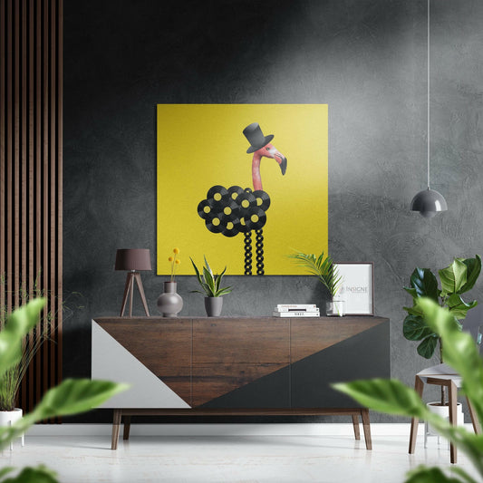 Modern interior showroom displaying yellow artwork with stylized flamingo wearing top hat on dark wood console table against textured gray wall.