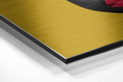 Close-up cross-section view showing layered composition of brushed gold aluminum top with black and white core layers of Dibond composite material.