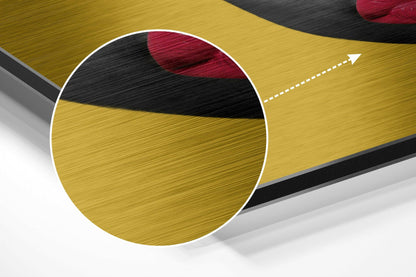 Close-up circular detail showing brushed aluminum surface with yellow, black, and red color bands and white border against white background.