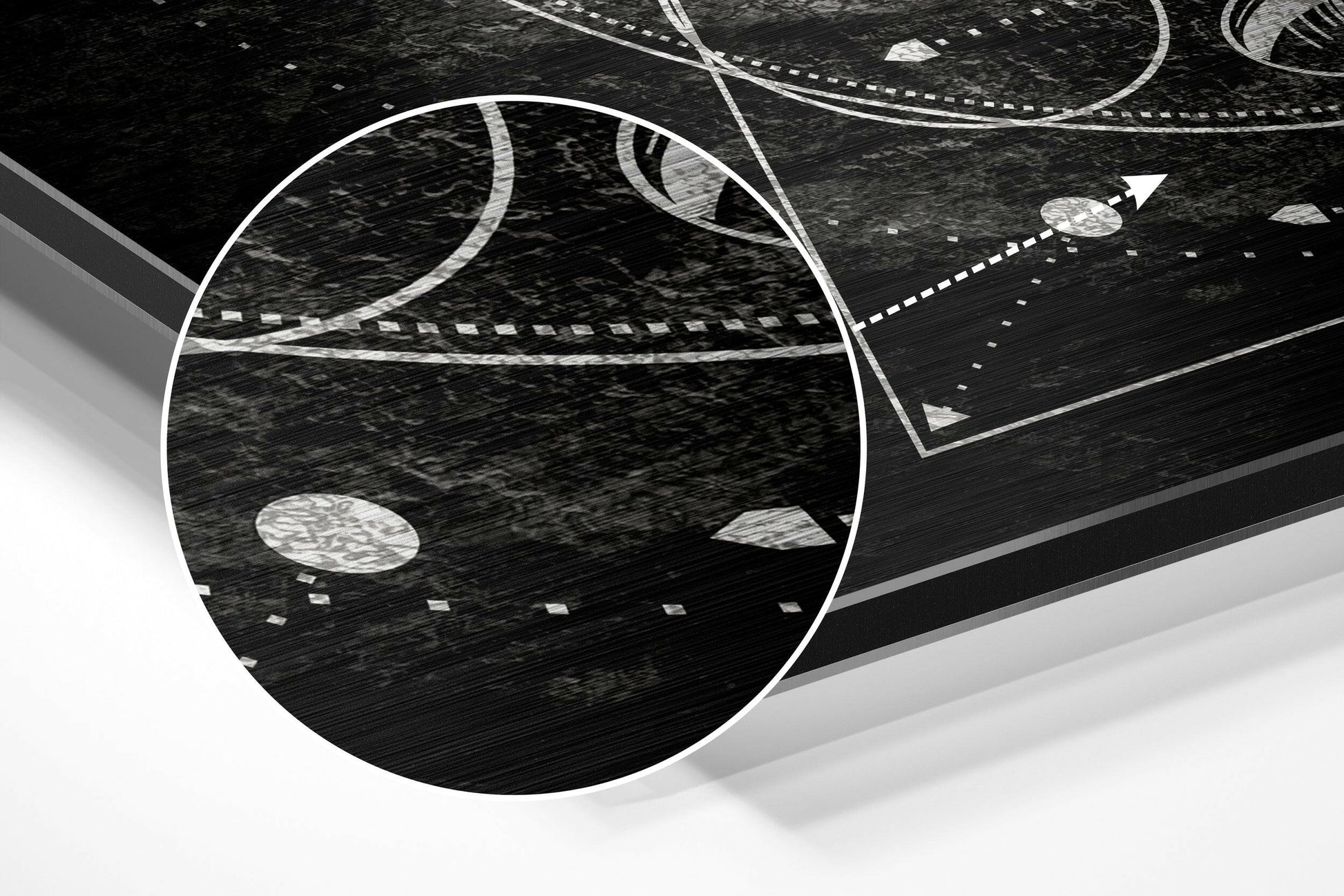 Angled perspective view of brushed aluminium wall art featuring white curved lines and geometric shapes on textured black surface.