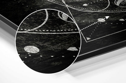 Angled perspective view of brushed aluminium wall art featuring white curved lines and geometric shapes on textured black surface.