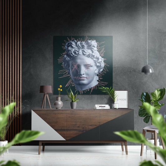 Modern interior display featuring a teal Dibond wall art with a classical statue head surrounded by radiating pink and gold lines, mounted above a wooden mid-century dresser.