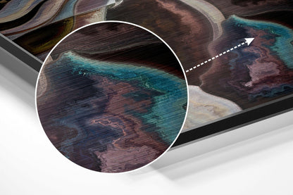 Close-up detail of brushed aluminium dibond showing turquoise and burgundy abstract brushstrokes with magnified circular inset.