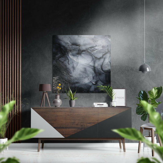 Charcoal smoke ink brushed aluminium Dibond wall art featuring abstract black and white swirling patterns, displayed above a wooden mid-century modern dresser in a contemporary interior setting.