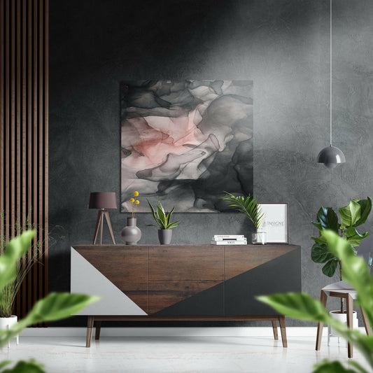 Modern living room interior with blush pink and gray abstract wall art displayed above a wooden dresser with plants and decor.