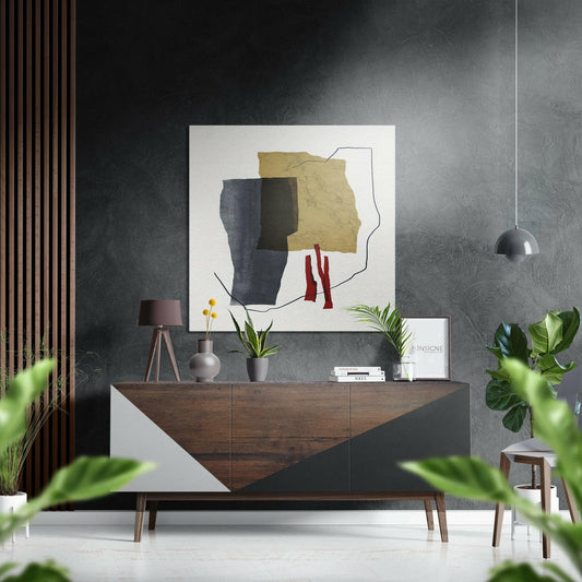 Modern interior with abstract art featuring yellow, navy, and burgundy shapes hung above a wooden dresser with potted plants and decorative items.