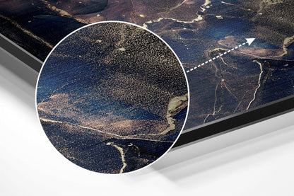 Aerial photograph of forested landscape with winding rivers and clearings, displayed as brushed aluminium wall art with magnified circular detail inset.