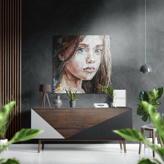 Portrait of a young woman with long hair on brushed aluminium panel hung above wooden console table in modern interior.