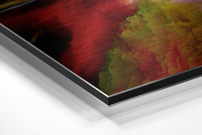 Angled perspective view of brushed aluminum Dibond wall art featuring red, yellow, and green abstract cloud patterns with black border and white backing.