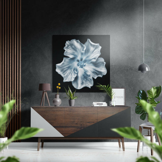 Blue and white hibiscus flower artwork displayed above wooden dresser in minimalist modern interior setting.