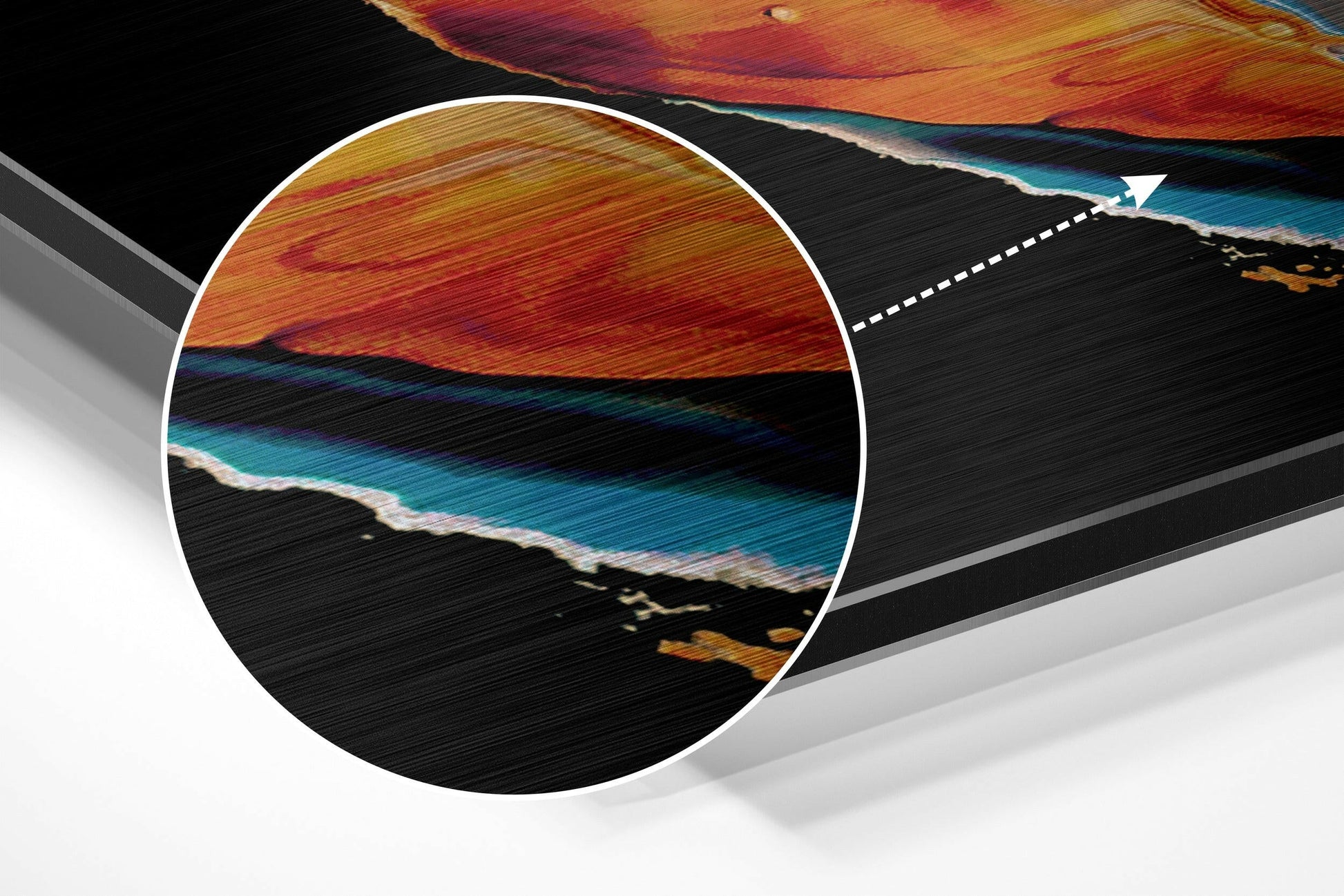 Close-up detail of brushed aluminum wall art showing orange, red, and teal striped pattern with circular magnification overlay and dashed pointer line.