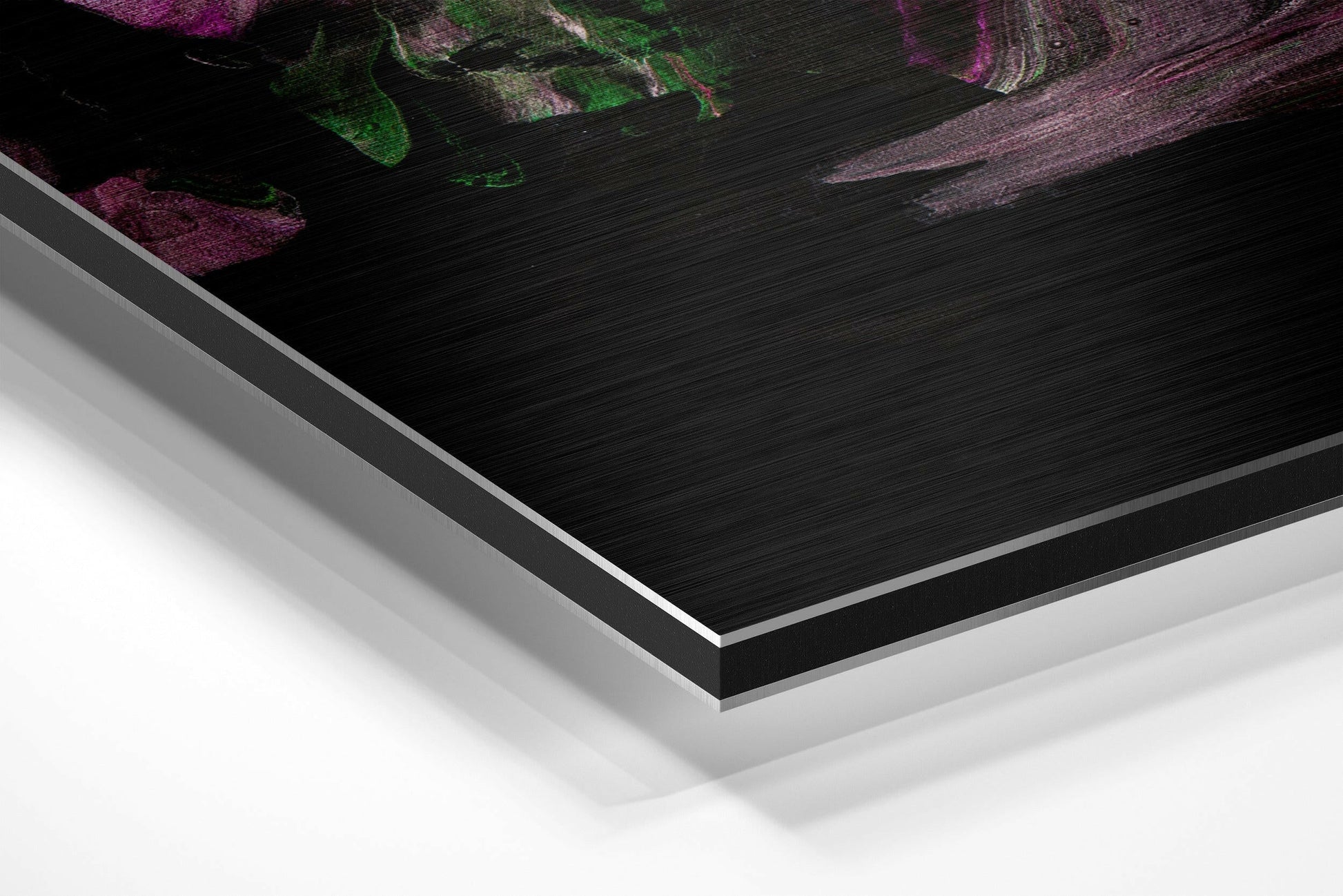 Close-up angled view of layered Dibond panel edges showing black brushed aluminum face with white backing and silver trim.