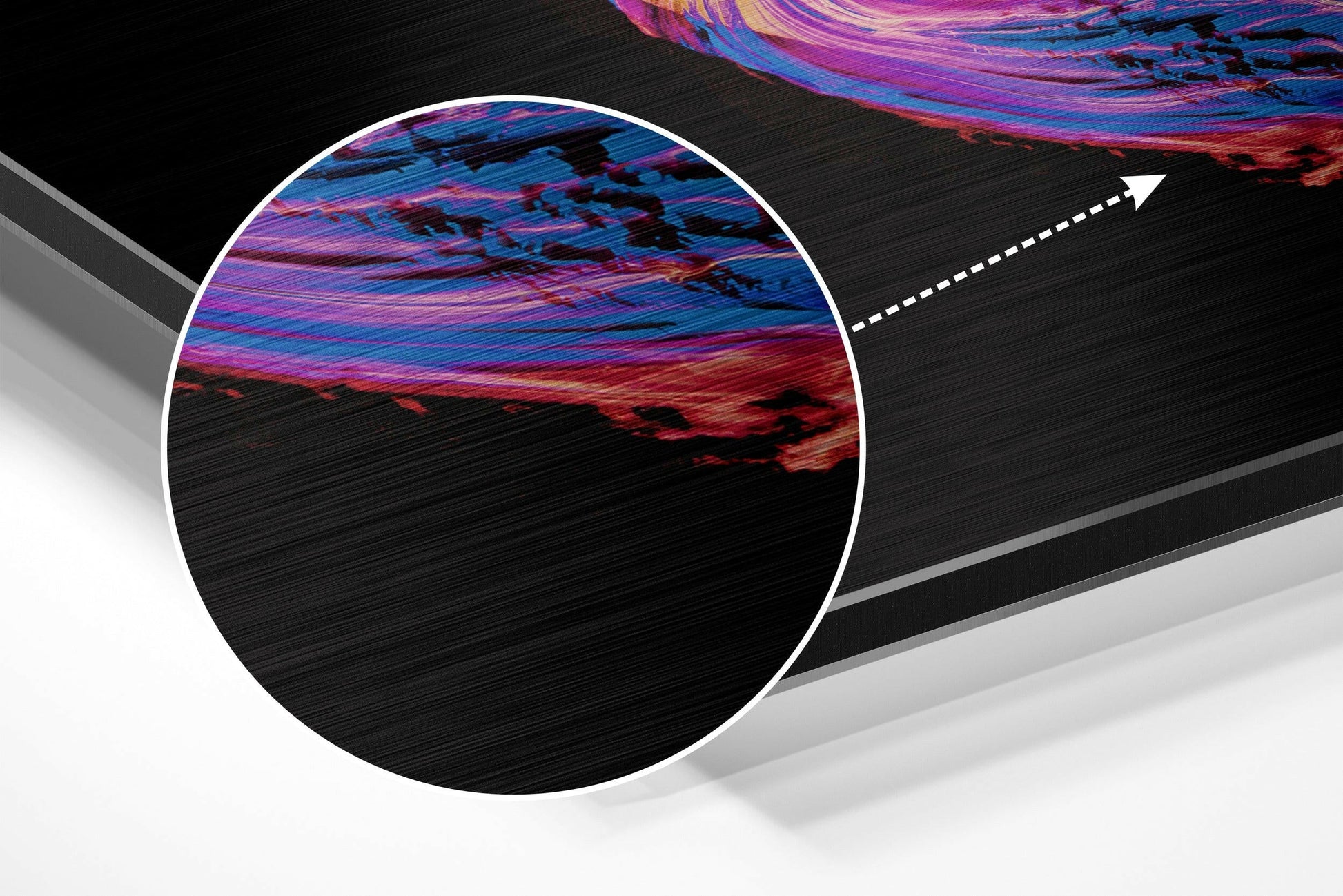 Close-up detail shot of brushed aluminum surface with vibrant pink, purple, and blue swirled patterns against black background.