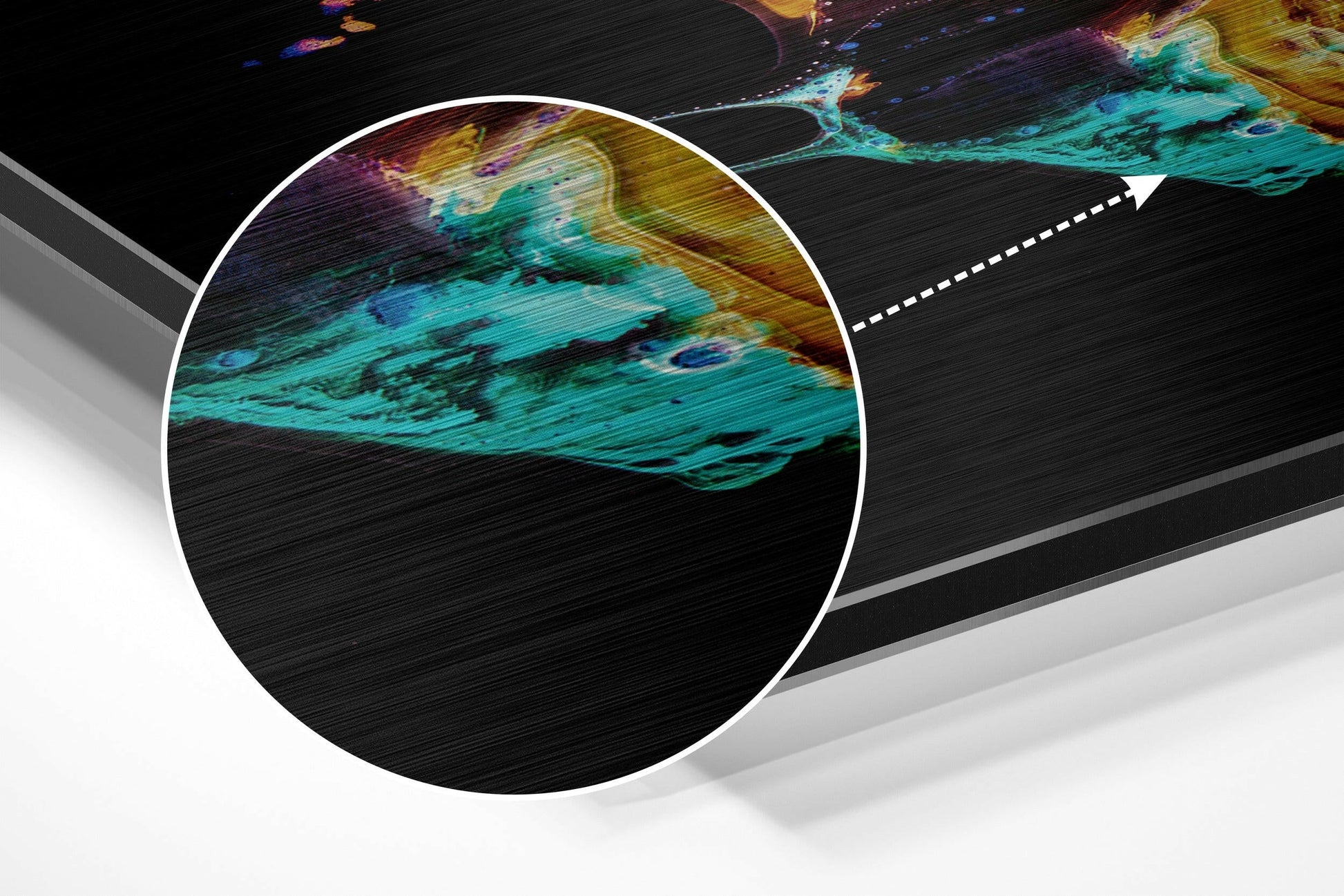Close-up detail of brushed aluminium surface showing turquoise, yellow, and purple abstract patterns with horizontal texture.