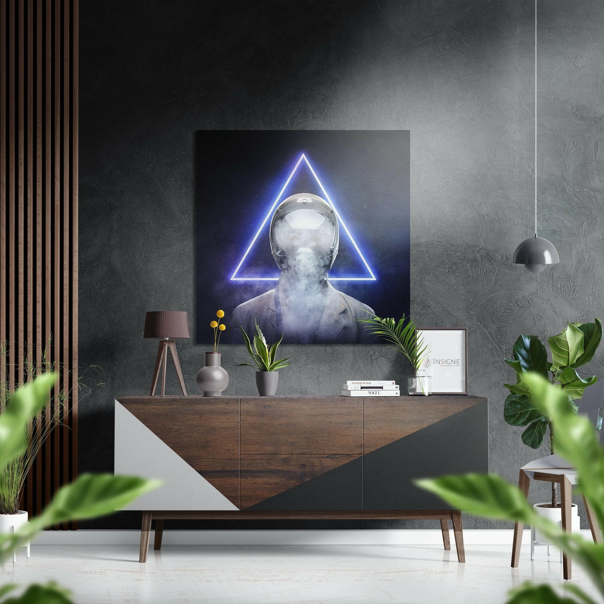Modern interior with neon-lit triangular wall art above wooden dresser, surrounded by plants and minimalist decor.