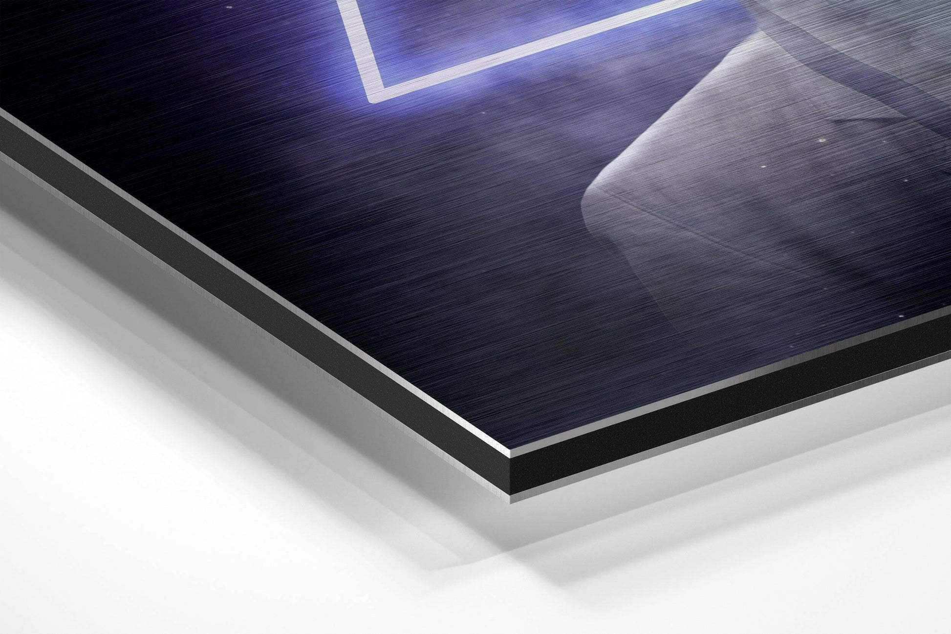 Close-up isometric view of layered brushed aluminum Dibond wall art with dark textured surface, black edge trim, and white backing visible at an angle.