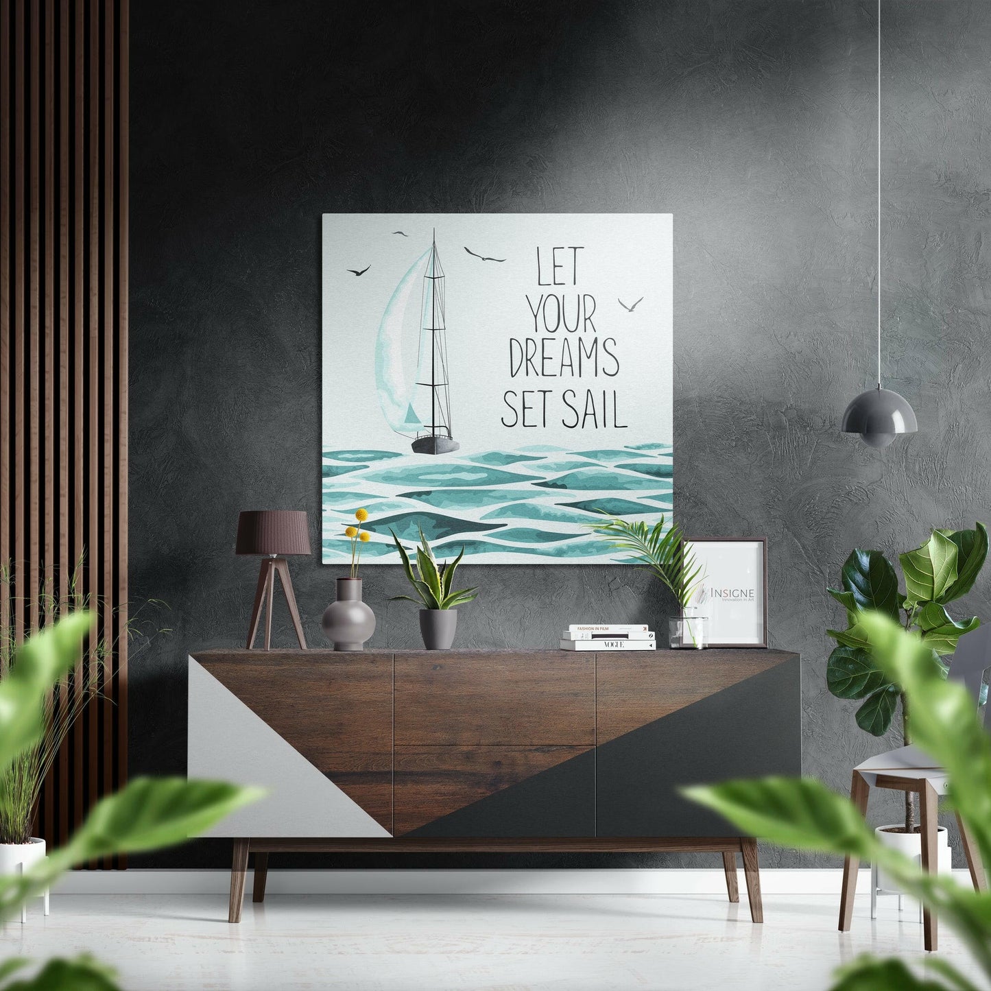 Modern interior displaying "Let Your Dreams Set Sail" sailboat wall art above wooden dresser with plants and accessories.