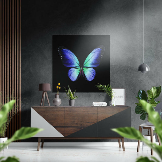 Blue and green butterfly artwork displayed above a wooden sideboard in a modern interior setting with plants and decor.