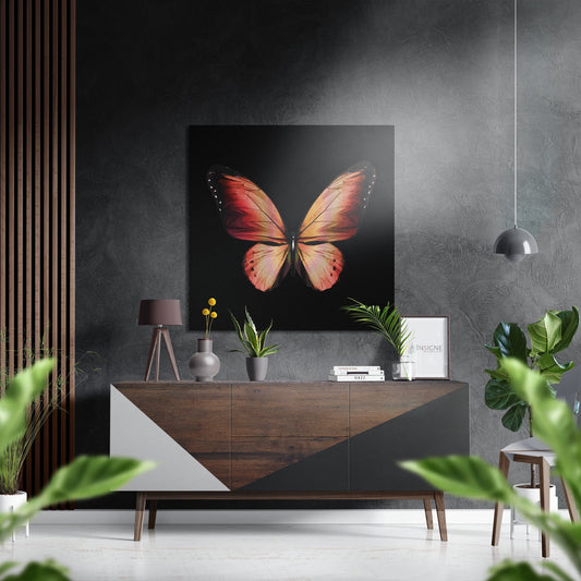 Coral orange butterfly artwork displayed above wooden dresser in modern gray interior with potted plants and pendant lamp.