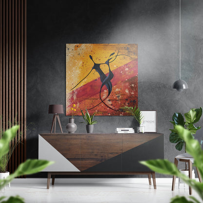 Modern interior with abstract figure artwork featuring warm orange and red tones displayed above wooden sideboard with plants and accessories.