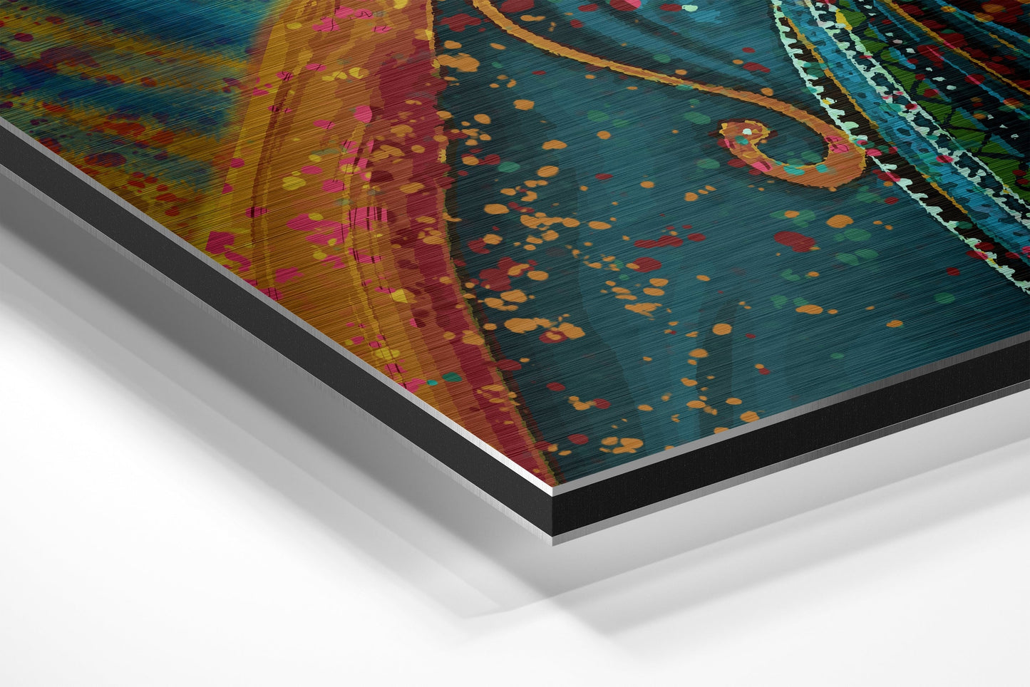 Angled perspective view of colorful Dervish Brushed Aluminium Dibond wall art showing layered material edges and vibrant teal, gold, red, and pink abstract patterns.