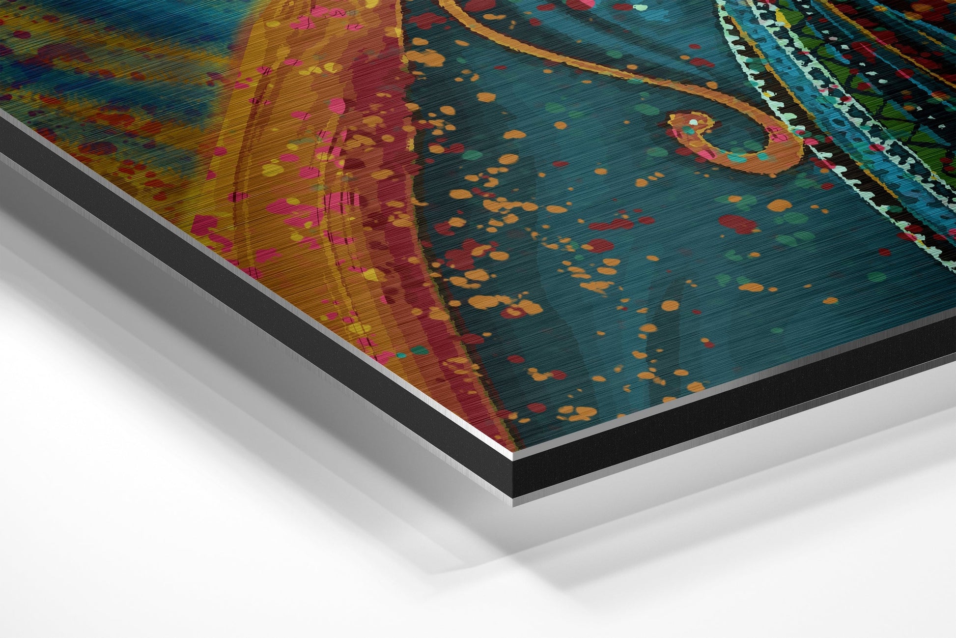 Angled perspective view of colorful Dervish Brushed Aluminium Dibond wall art showing layered material edges and vibrant teal, gold, red, and pink abstract patterns.