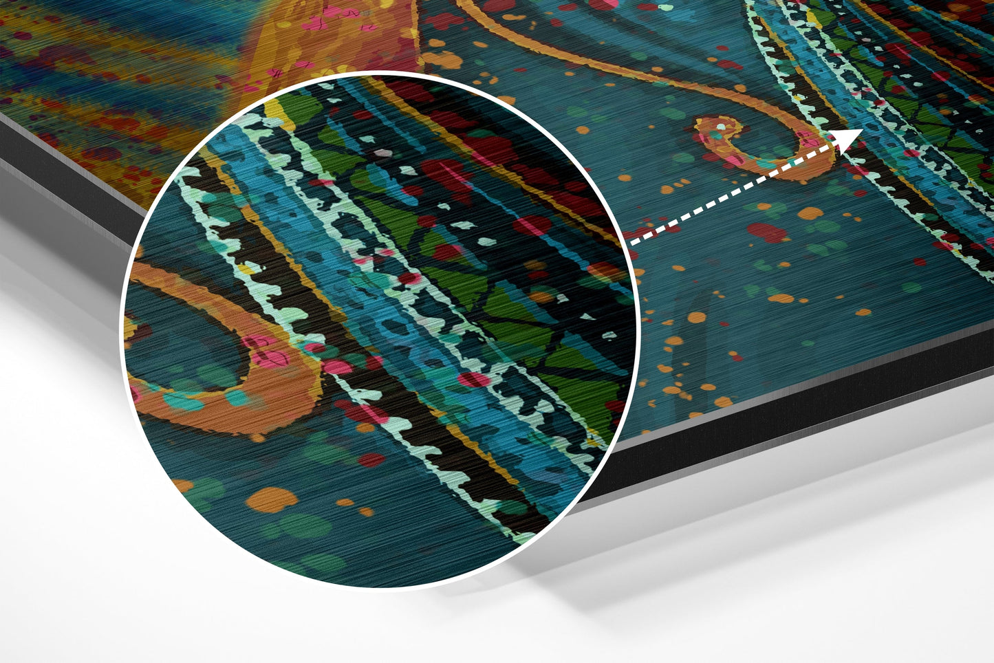 Close-up detail of brushed aluminium surface showing multicolored geometric patterns in blue, green, orange, and white with linear texture.