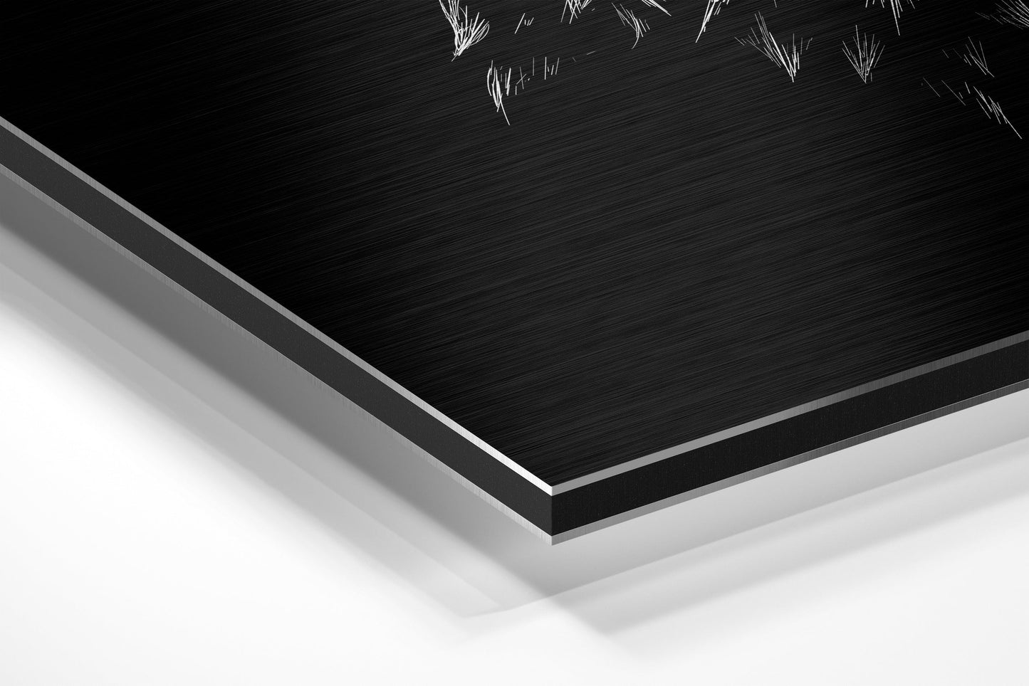 Close-up angled view of layered Dibond panel showing black brushed aluminium surface with white core edge and partial owl artwork visible at top.