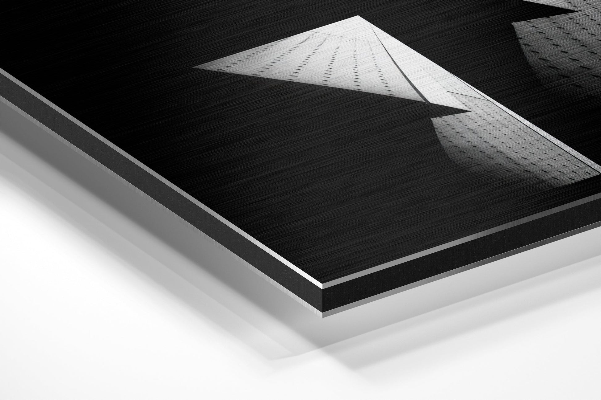 Isometric product view showing layered construction of brushed aluminum dibond wall art with black textured surface and white backing layers.