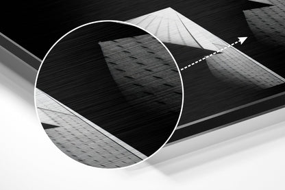 Abstract architectural composition featuring circular brushed aluminum frame with geometric building facades in black and white tones.