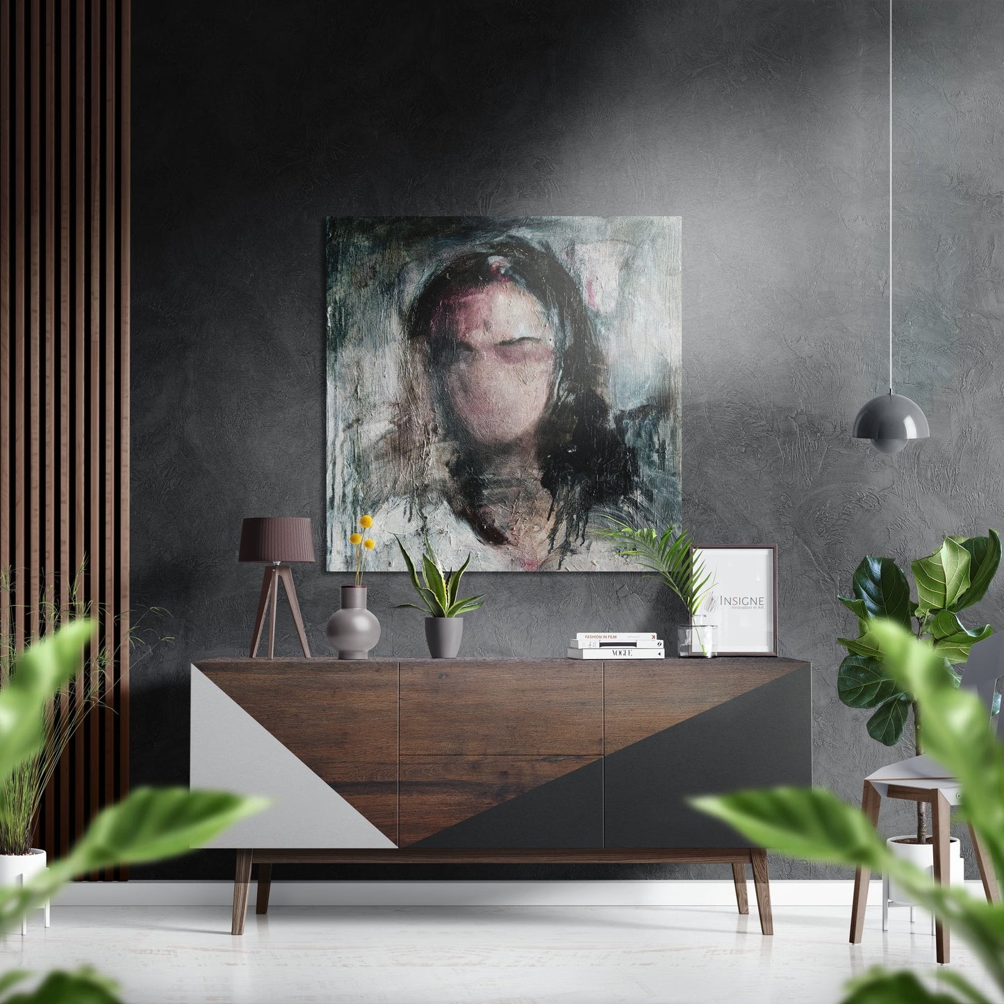 Contemporary interior scene featuring a portrait artwork hung above a wooden dresser with geometric white panels, surrounded by potted plants and decorative objects.