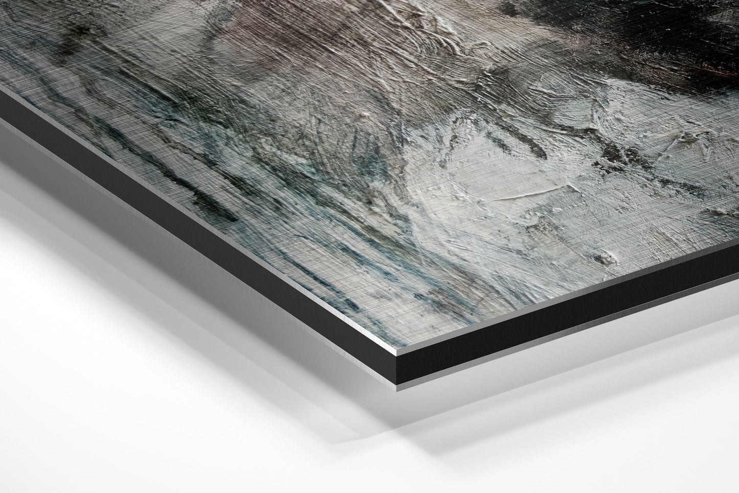 Angled perspective view of brushed aluminium Dibond wall art showing layered edges and gray textured surface with black border frame.