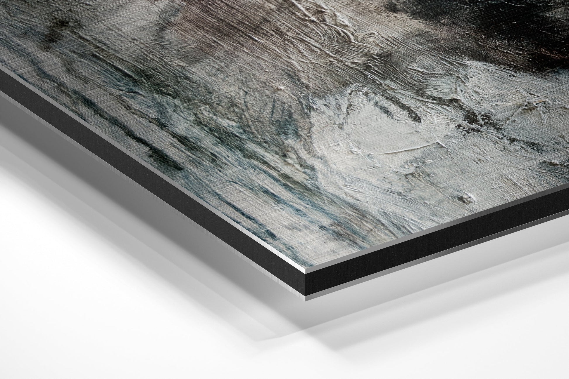 Angled perspective view of brushed aluminium Dibond wall art showing layered edges and gray textured surface with black border frame.
